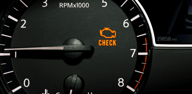 Dashboard of a vehicle displaying a lit check engine light. Get accurate check engine diagnostics at Autovisions in Englewood.