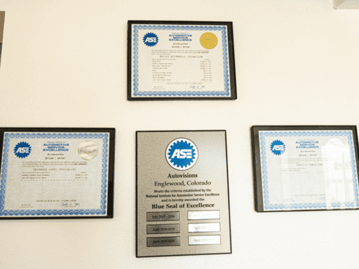 ASE Certified Auto Repair Shop in Englewood, CO by Autovisions. Wall displaying multiple ASE certification plaques and awards, signifying the shop's commitment to excellence and professional standards in automotive service and repair.