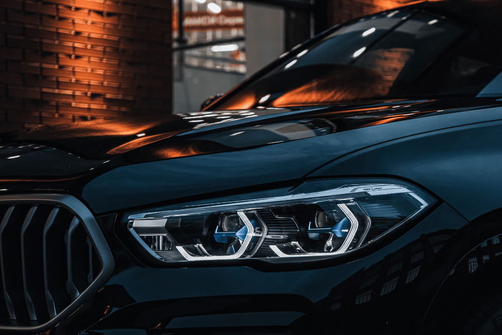 bmw drivetrain malfunction, auto repair in Englewood, CO at Autovisions. Close-up view of the headlight and front grille of a modern BMW.