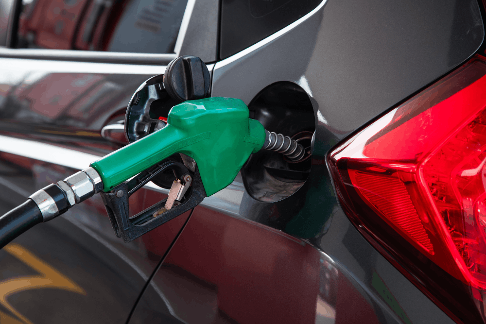 Fuel mileage, auto repair in Englewood, CO at Autovisions. Image of vehicle refueling at the gas pump, highlighting the importance of preventative auto maintenance and engine performance services to help improve gas mileage and driving reliability.
